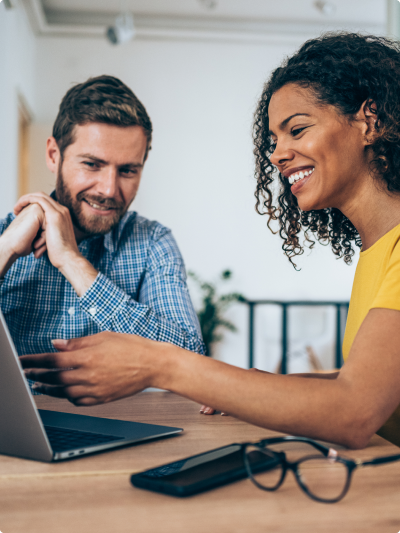 two people looking at a laptop screen