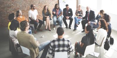 People sitting in a circle talking.